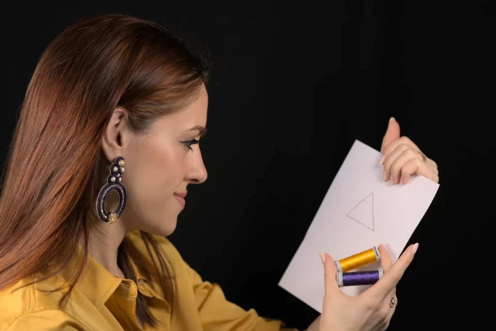 A selection of colorful embroidery threads and crystals arranged to create a harmonious textile artwork.