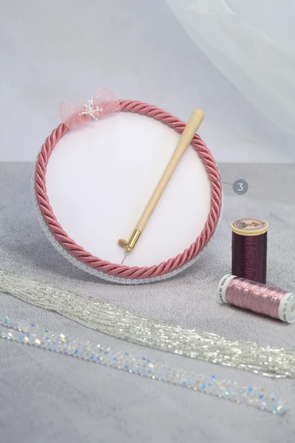 Warm pink Starlight embroidery beading plate with Lunéville hook, metallic threads, beads, and crystals for haute couture beading.