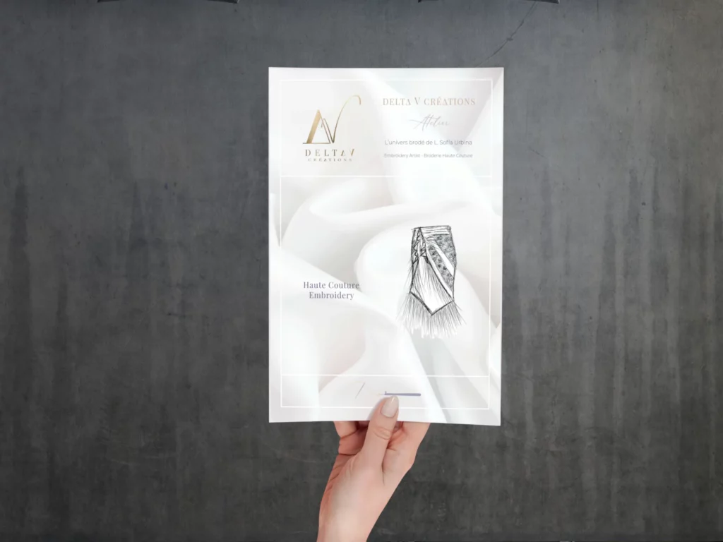 A close-up of an official Delta V Créations contract document, symbolizing the commitment to craftsmanship and personalized couture embroidery services.