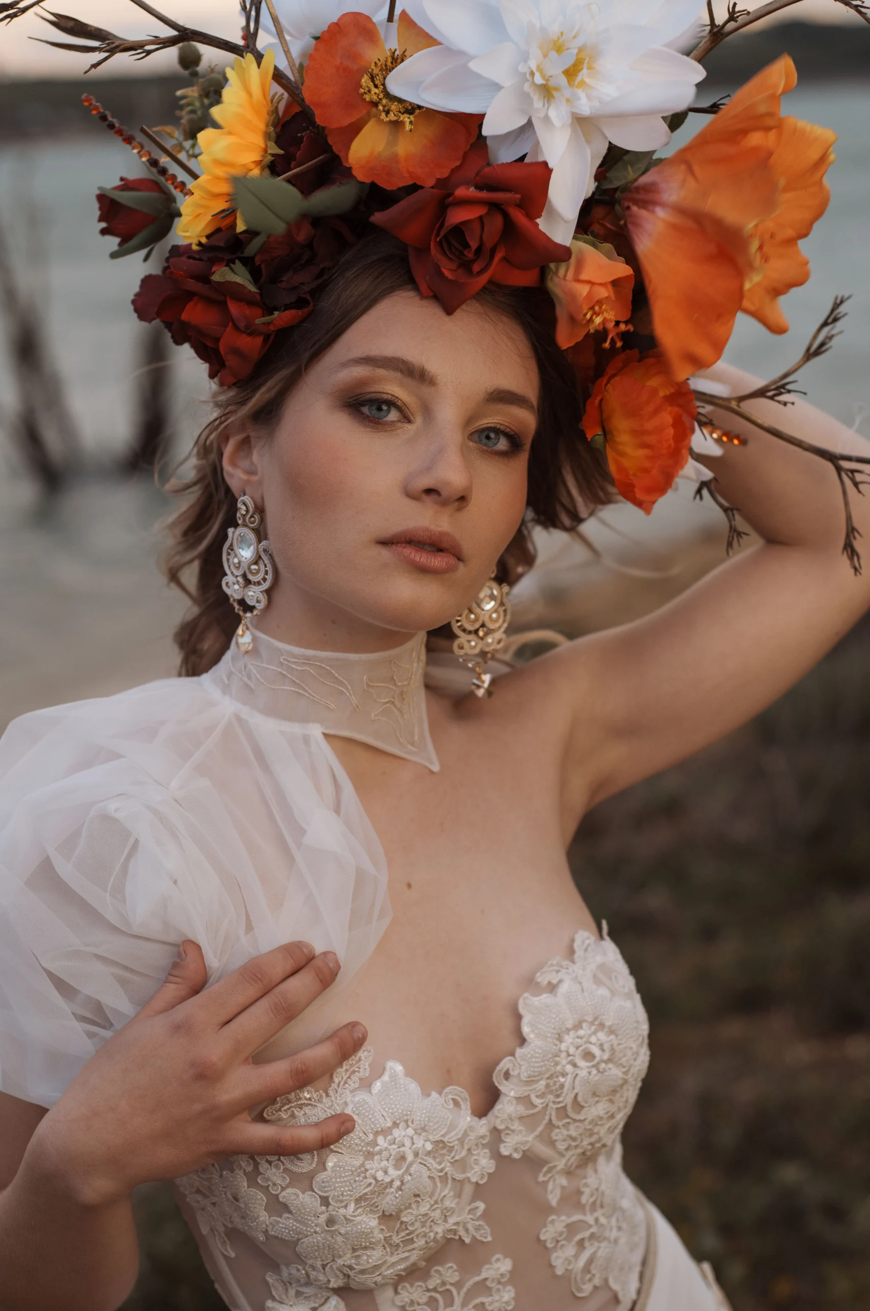 Bride wearing a delicate embroidered wedding gown with elegant details and handcrafted earrings, showcasing bespoke bridal accessories.