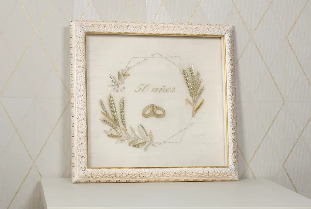 Elegant framed embroidery artwork featuring a wedding gift for marriage, with gold wheat, wedding rings, and a delicate floral design for a timeless gift.