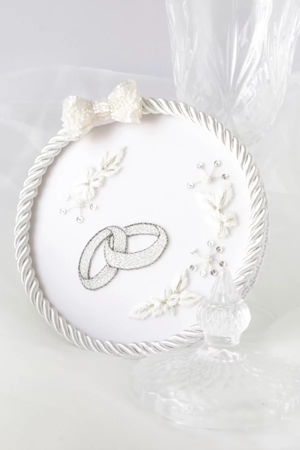 Elegant wedding ring holder with custom embroidery, personalized to match the bride's dress for a unique an elegant creation.