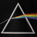 Detailed embroidery of prism and rainbow spectrum with beads and silk thread, illustrating light refraction in the Newton artwork.