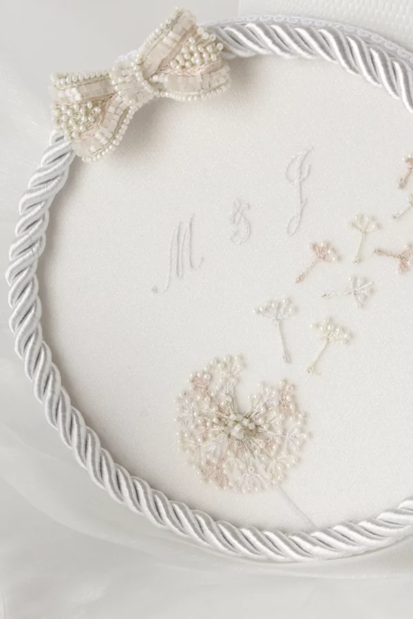 Dandelion wedding ring holder with custom embroidery, personalized to match the newlywed’s invitations.