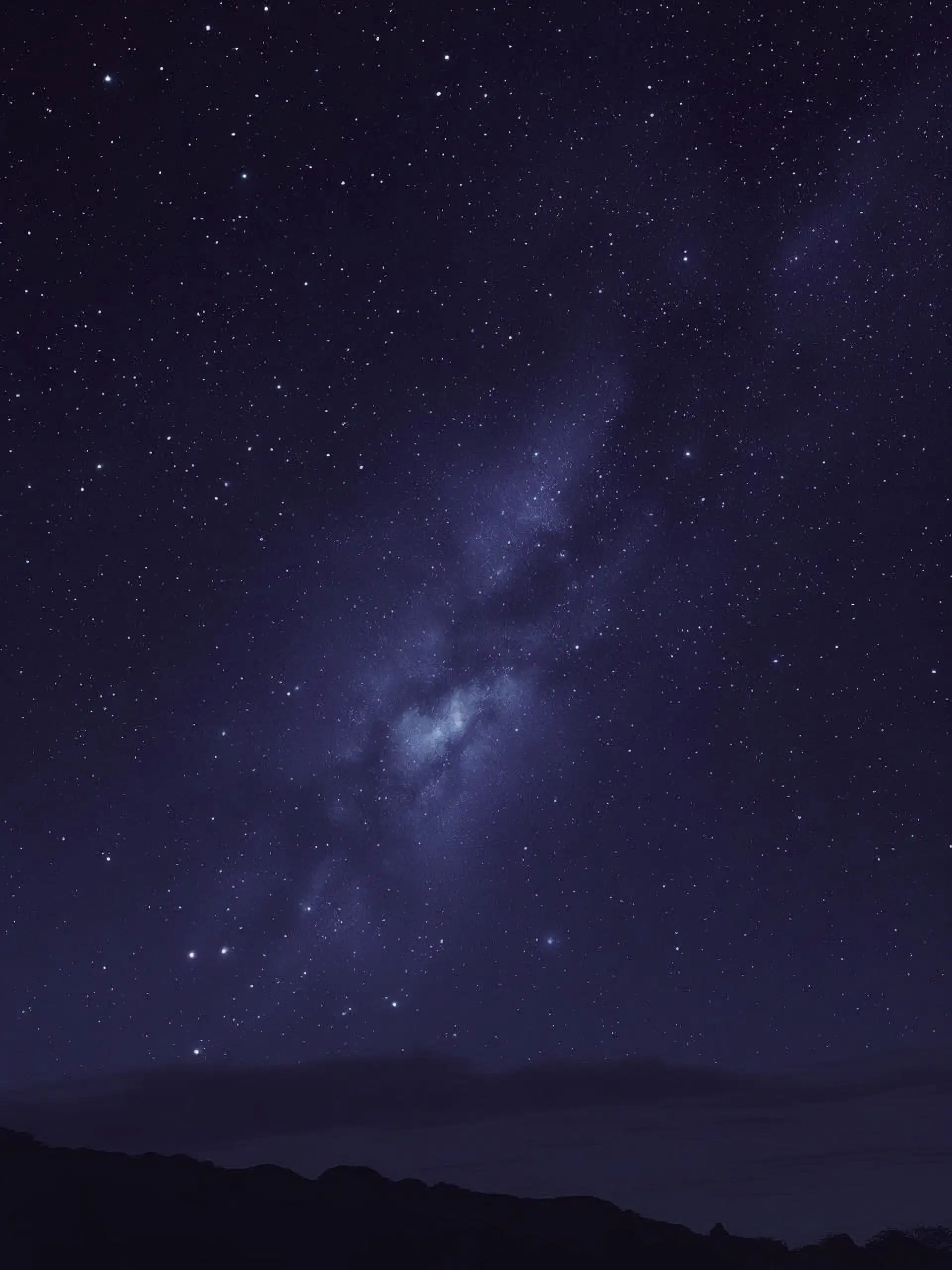 A starry midnight blue sky with bright stars in the foreground and blurred ones in the background.