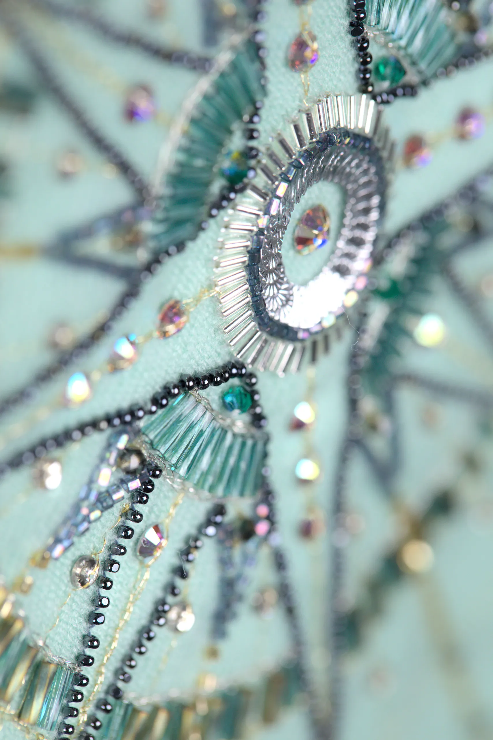 Gros plan de la broderie de l’écharpe en cachemire Alcyone avec perles et cristaux.