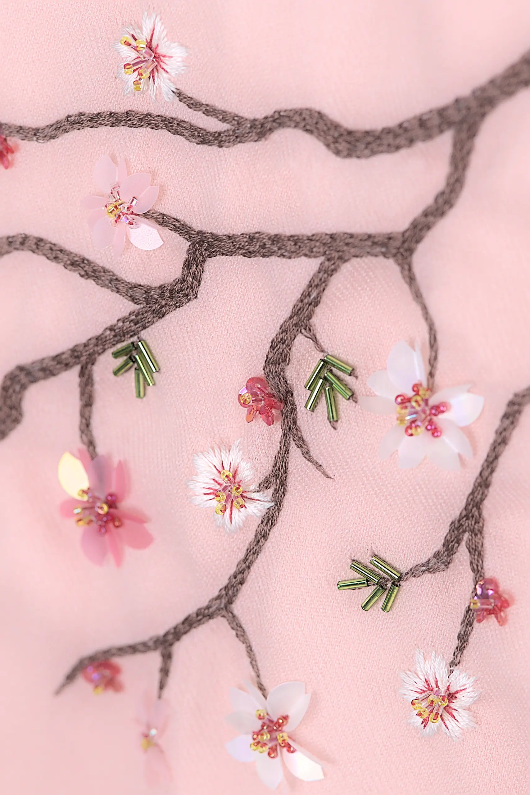 Détail de la broderie Maia sur l’écharpe en cachemire, avec paillettes, cristaux et branche de cerisier.